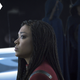 Sonequa Martin-Green's Captain Michael Burnham looks anxious as she sits by a group of robed, hooded Qowat Milat nuns with their backs toward her